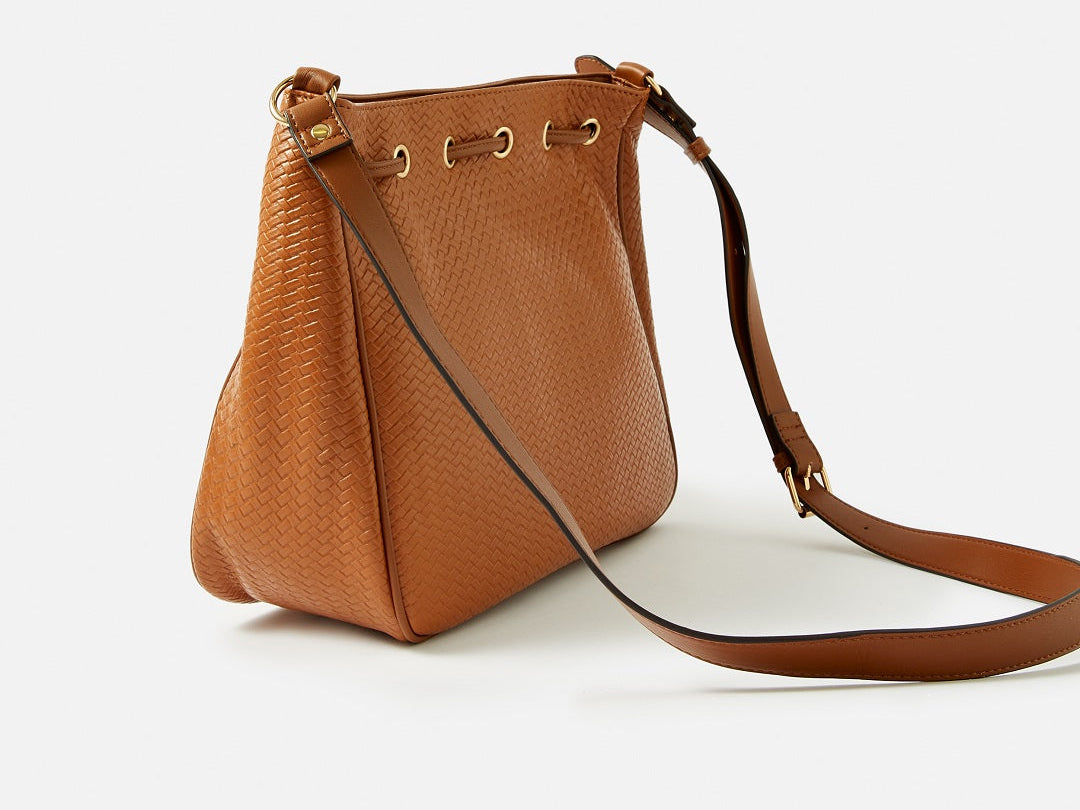 Accessorize London women's Faux Leather Tan Drawstring Weave Sling bag